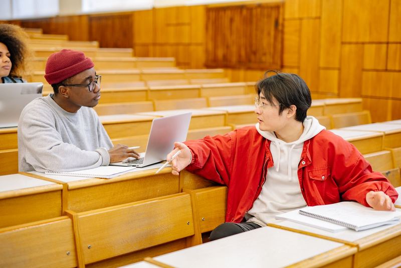 Two students discussing work during class